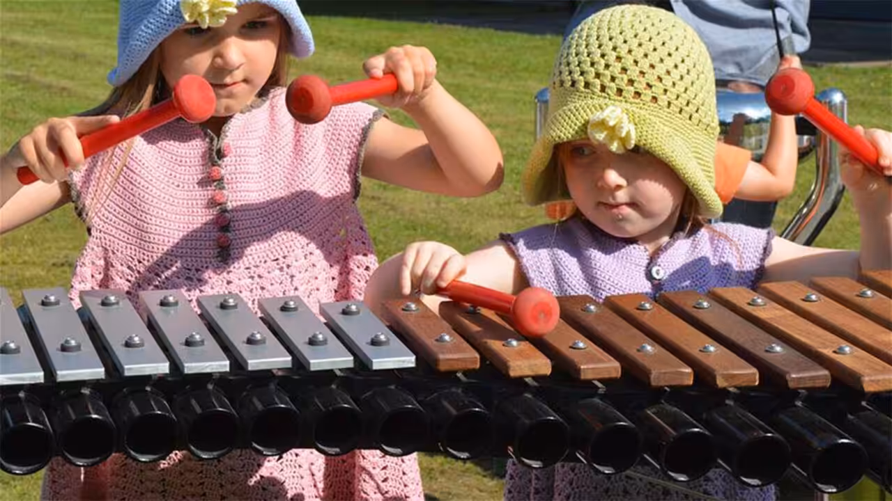 Kreativität entfalten im Park Kinder entdecken ihre Liebe zur Musik an Freiluft-Instrumenten.